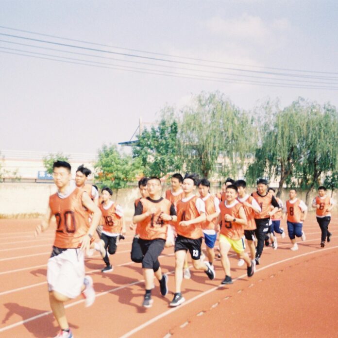 Photo by 志轩 肖 a group of young men running on a track