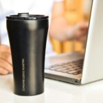 ‘마시는 건강 습관’…일상 속 물 섭취, 어떻게 실천할까? a black coffee cup sitting next to a laptop