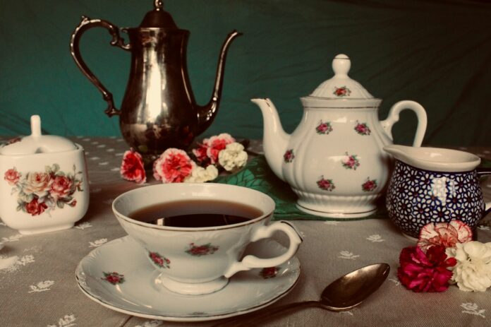 Photo by Every Angle white and red floral ceramic teapot on table