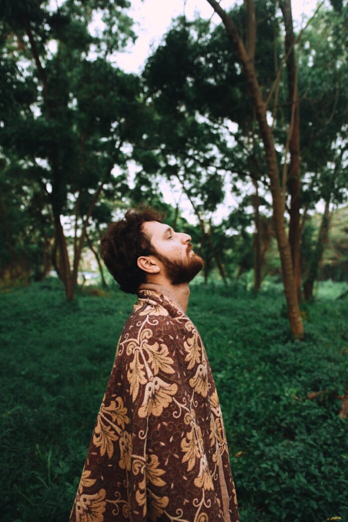 Photo by Arun Sharma man standing near tree